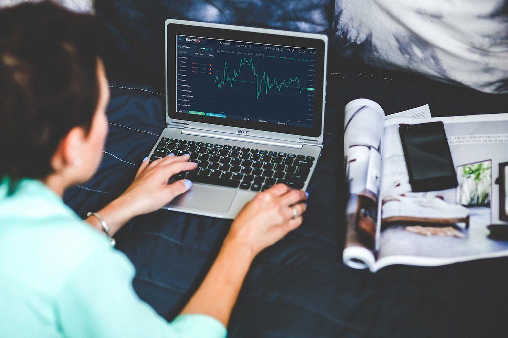 A person checking a crypto price chart on a laptop