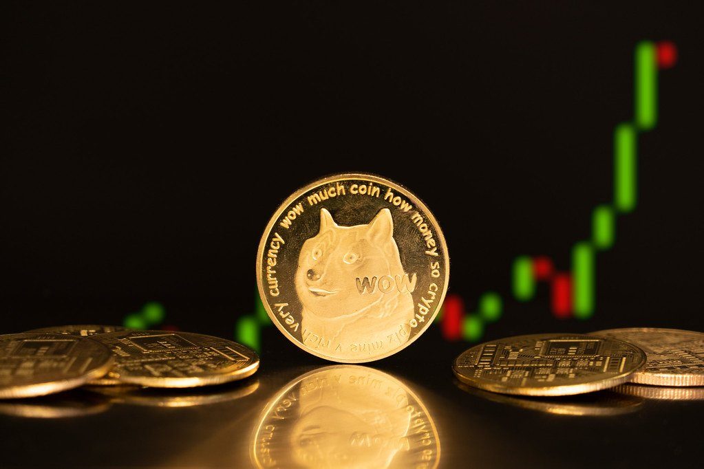 Novelty crypto coins in front of a rising candlestick chart