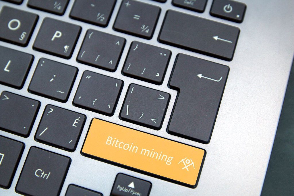 A laptop keyboard with an orange key labelled Bitcoin mining