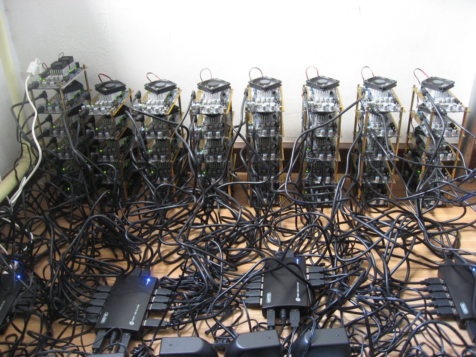 Rows of small mining machines with tangled power cables