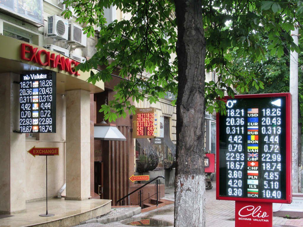 An electronic currency exchange rate board on a street