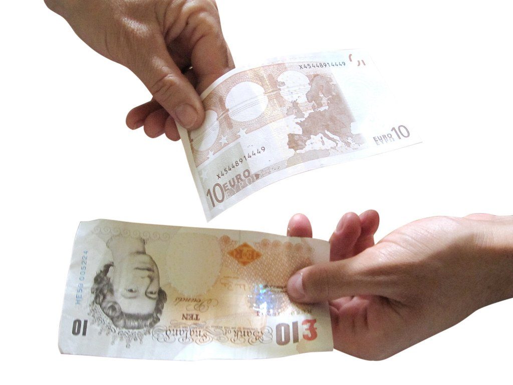 One person handing banknotes to another